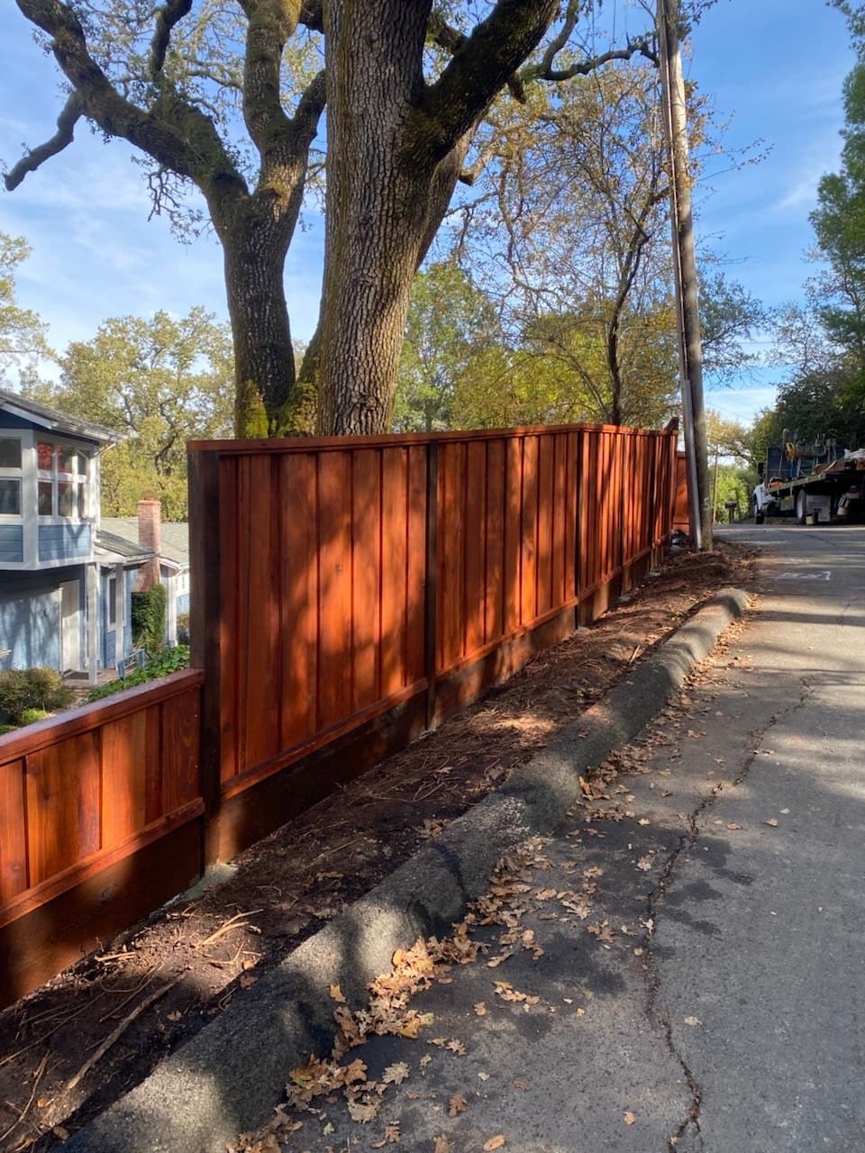 Board On Board Fence On Slope